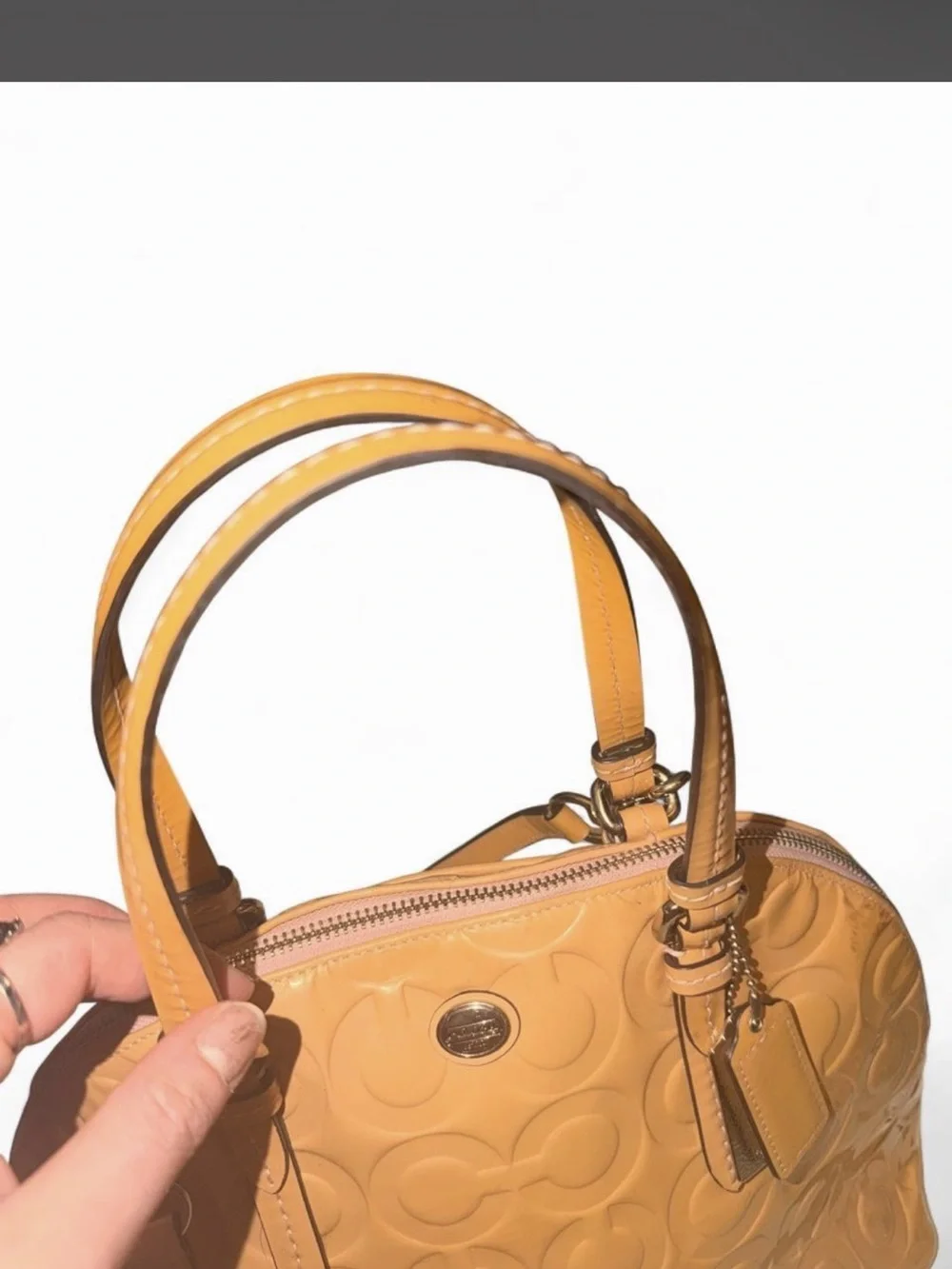 Coach - Peyton Cora in Tan Glossy PVC crossbody with a metallic finish